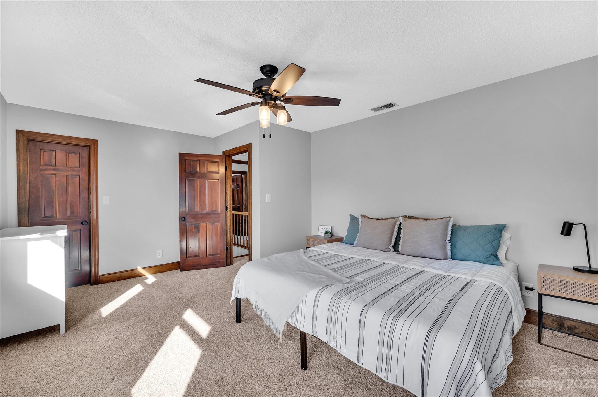 700 West Zion Church Road Shelby, NC 28150 - Photo 24 of 45 a spacious bedroom with a bed and a chandelier
