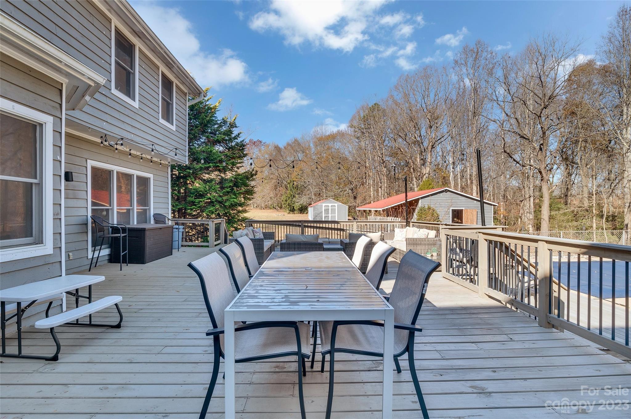 700 West Zion Church Road Shelby, NC 28150 - Photo 36 of 45 a view of a roof deck with table and chairs with wooden floor and fence