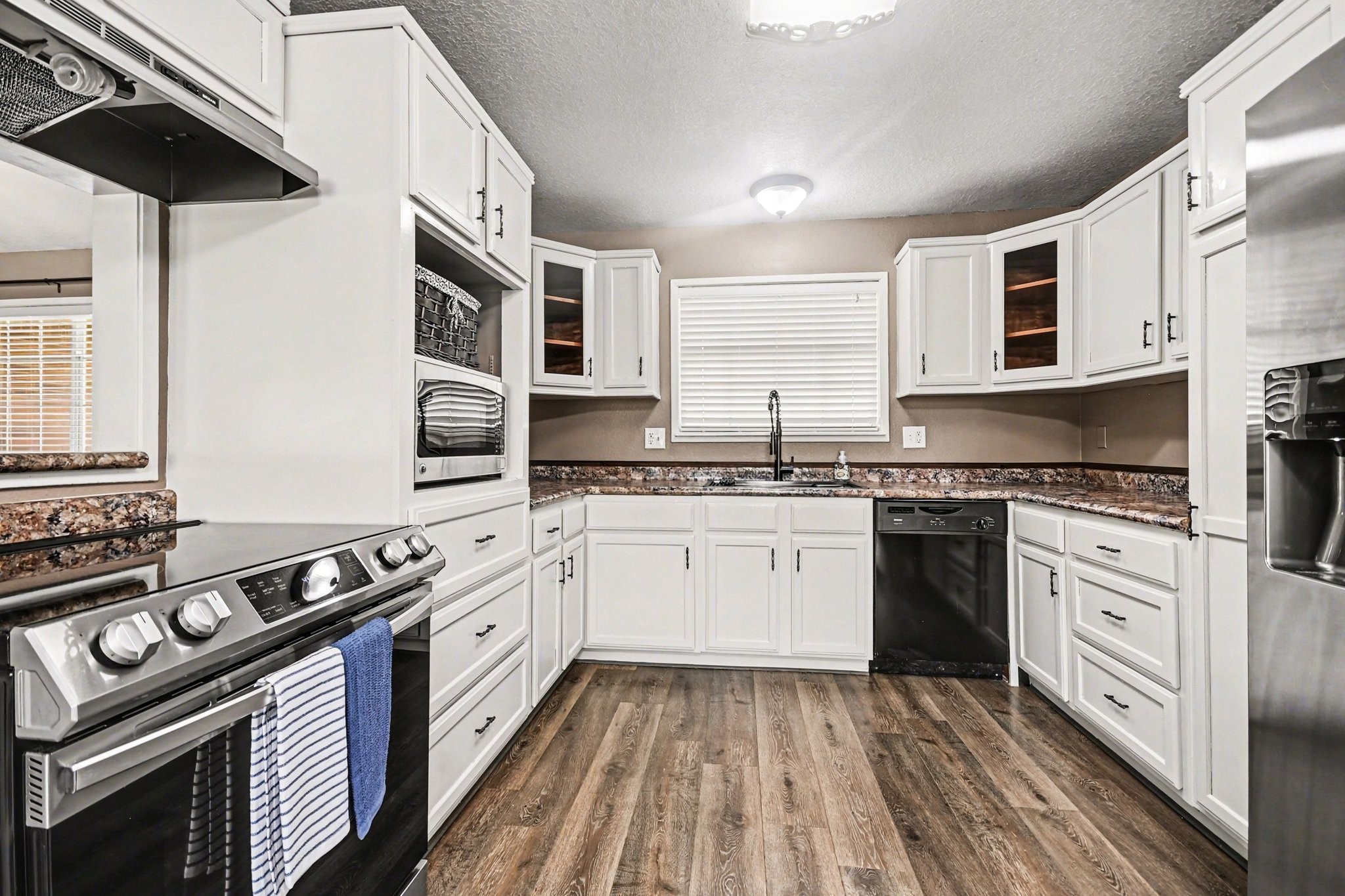 21503 Pecan Bend Road Damon, TX 77430 - Photo 14 of 45 a kitchen with stainless steel appliances granite countertop a stove and a sink