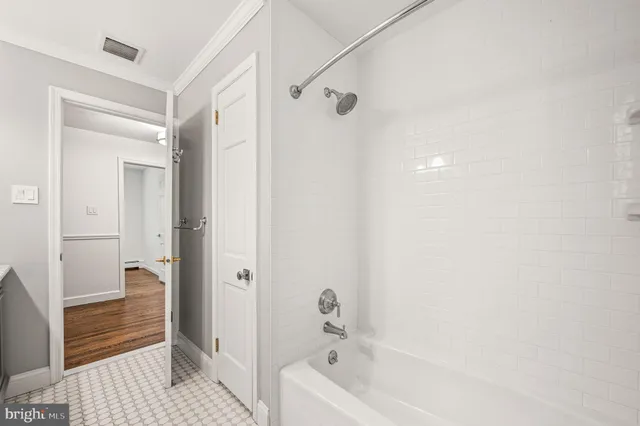a bathroom with a granite countertop double vanity sink a mirror and a toilet