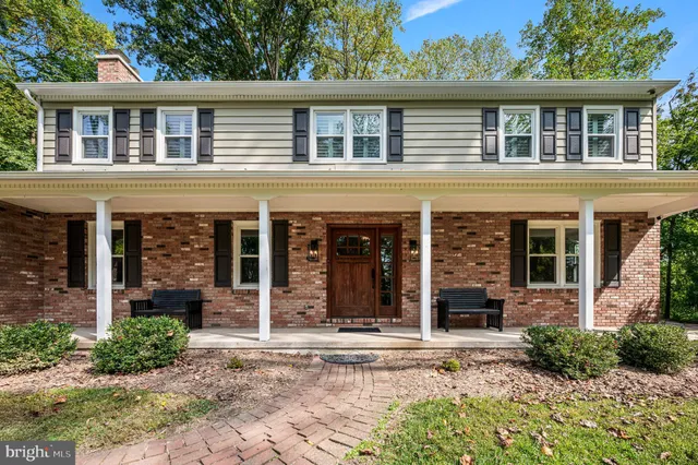 an aerial view of residential houses with outdoor space and swimming pool