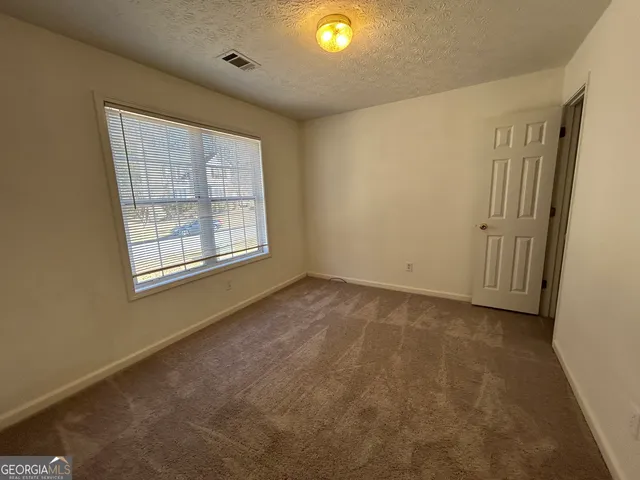 a bathroom with a granite countertop sink toilet a mirror and shower