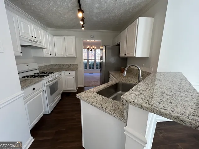 a kitchen with a refrigerator and a stove