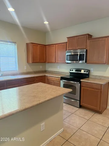 a view of a kitchen with a sink and a chandelier