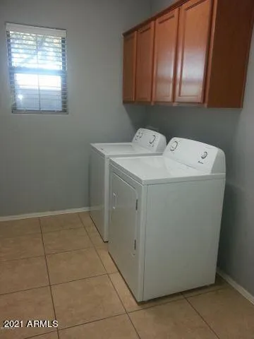a spacious bathroom with a double vanity sink and a mirror