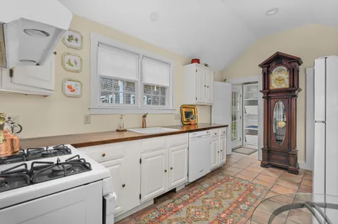 a kitchen with stainless steel appliances a stove a sink and a refrigerator