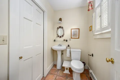 a white toilet sitting next to a bathroom sink