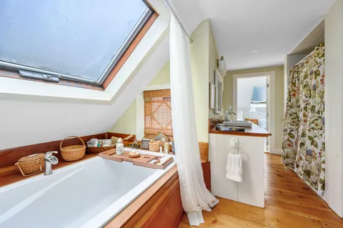 a room with a table chairs and a refrigerator