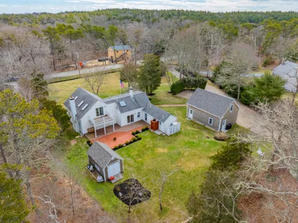 an aerial view of a house with garden space and outdoor seating