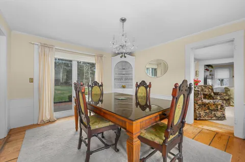 a view of a dining room with furniture and a chandelier