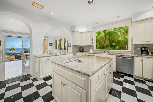 a kitchen with a sink a stove a refrigerator and cabinets