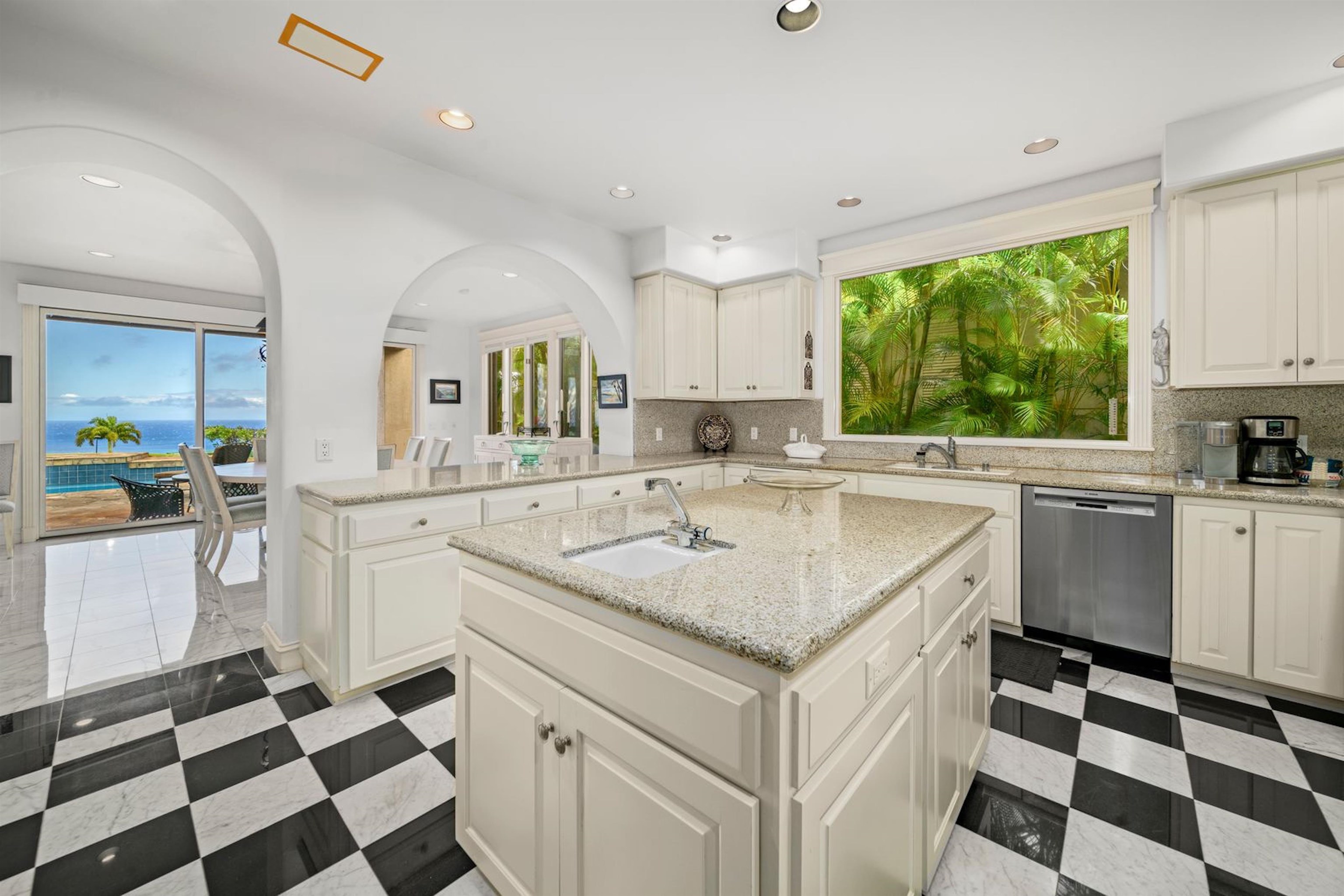 212 Crestview Road Lahaina, HI 96761 - Photo 18 of 50 a kitchen with a sink a stove a refrigerator and cabinets