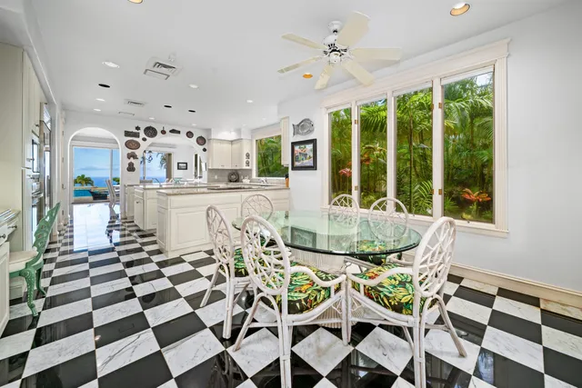 a view of a dining room with furniture and a floor to ceiling window