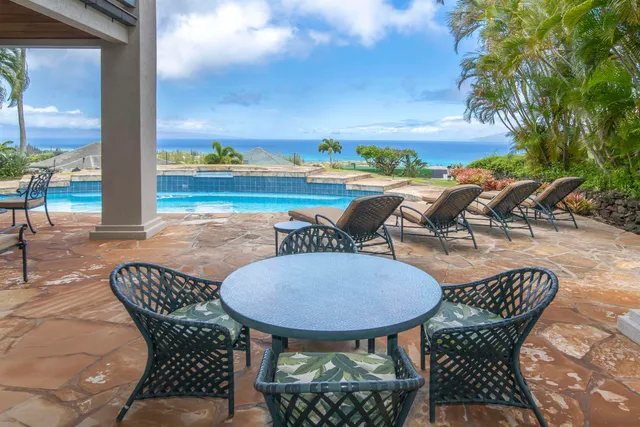a view of a chairs and table in patio