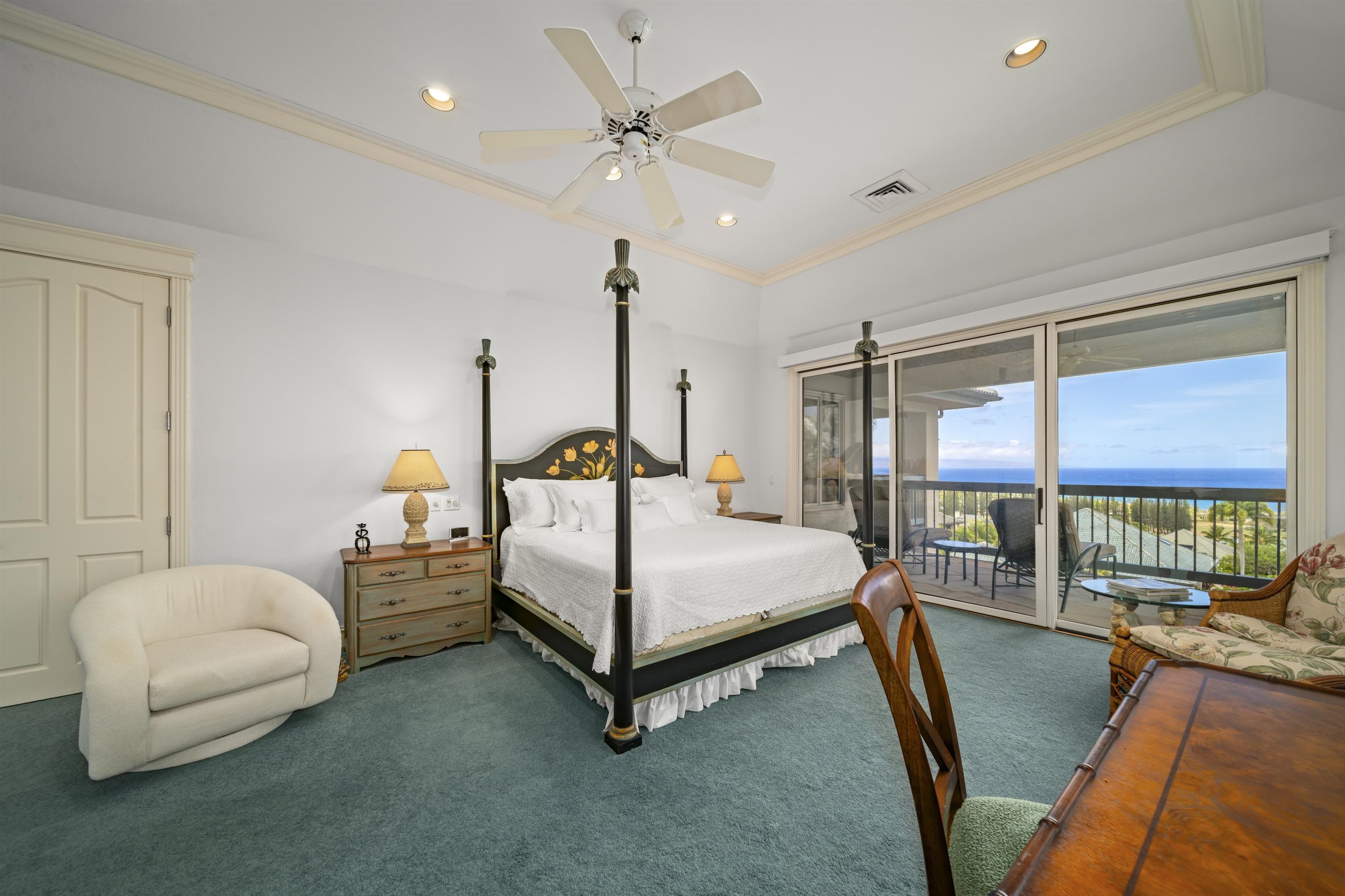 212 Crestview Road Lahaina, HI 96761 - Photo 29 of 50 a bedroom with a bed a couch and a chandelier