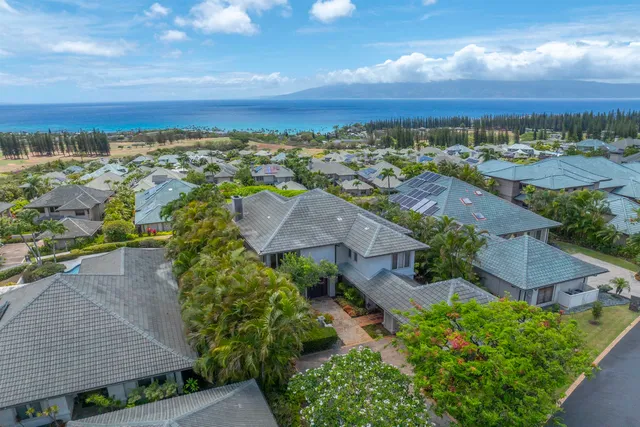 an aerial view of residential houses with outdoor space and street view