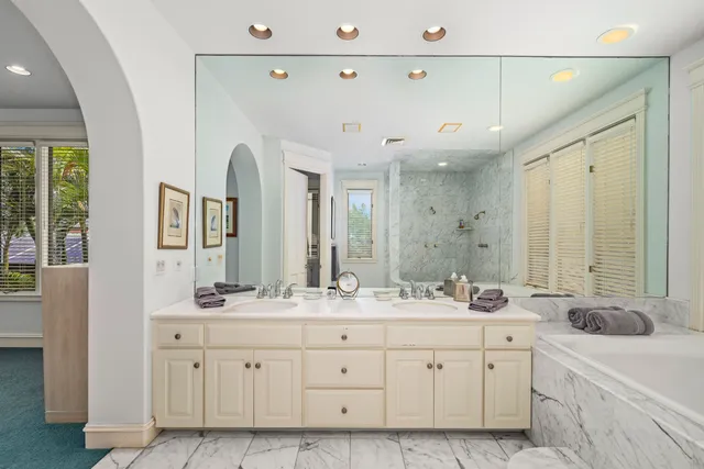 a spacious bathroom with double sink and a mirror