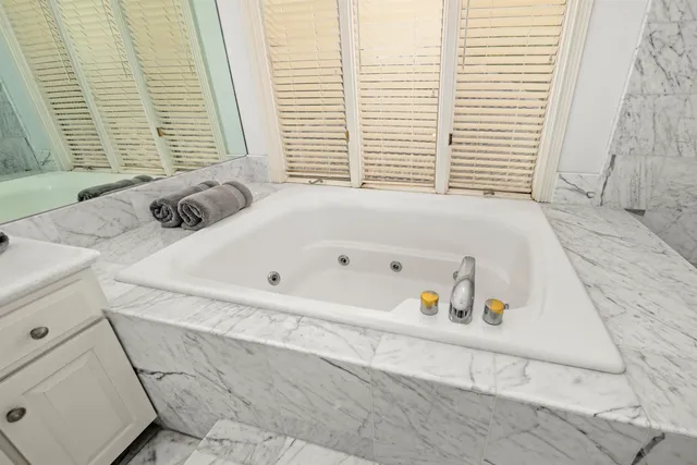 a bathroom with a bathtub and a window