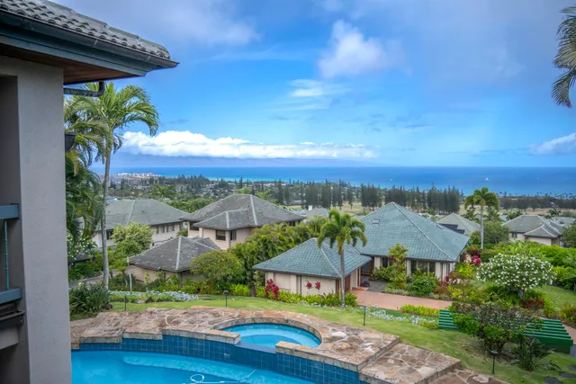 an aerial view of a house with yard and lake view