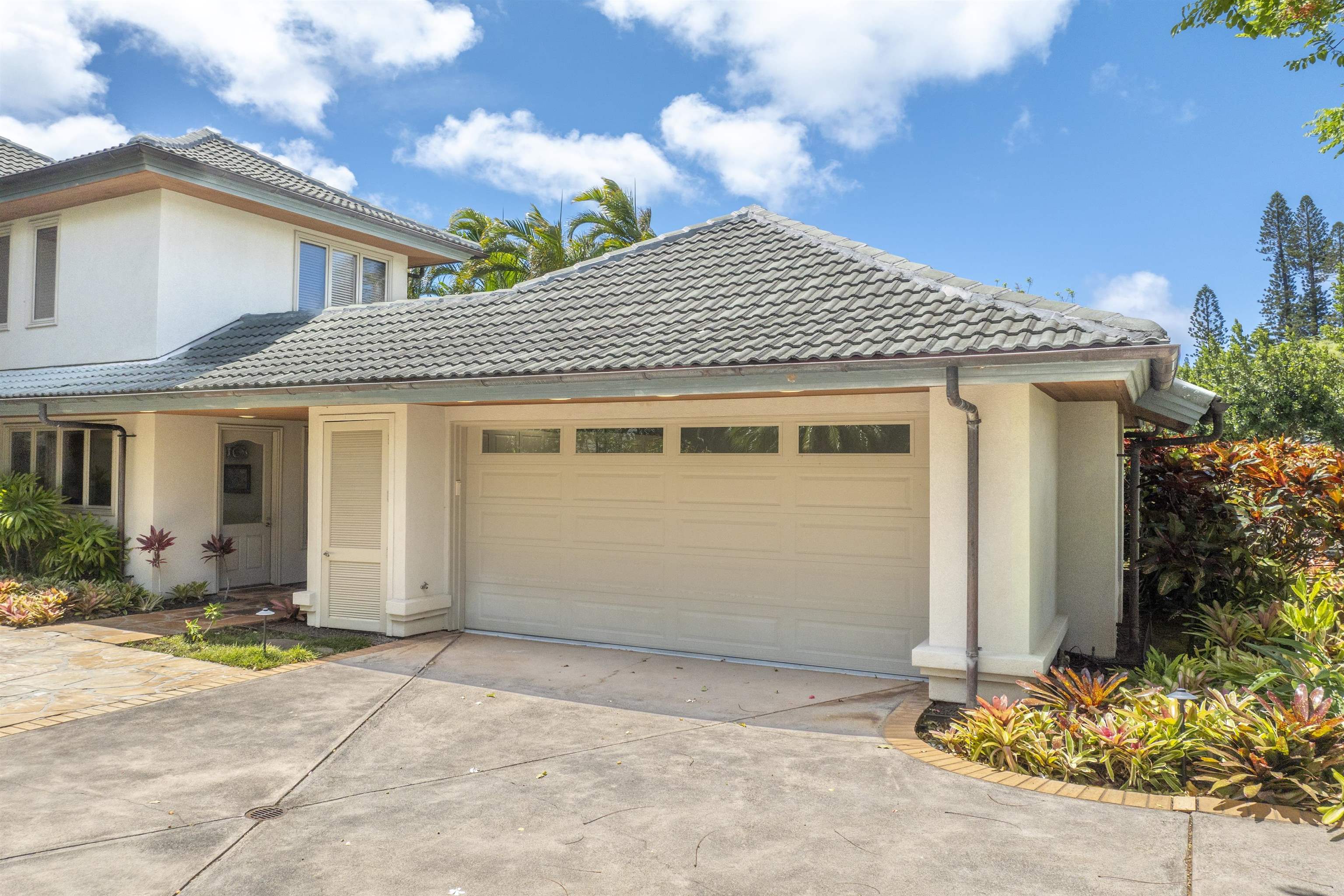 212 Crestview Road Lahaina, HI 96761 - Photo 47 of 50 a front view of a house with a yard and garage