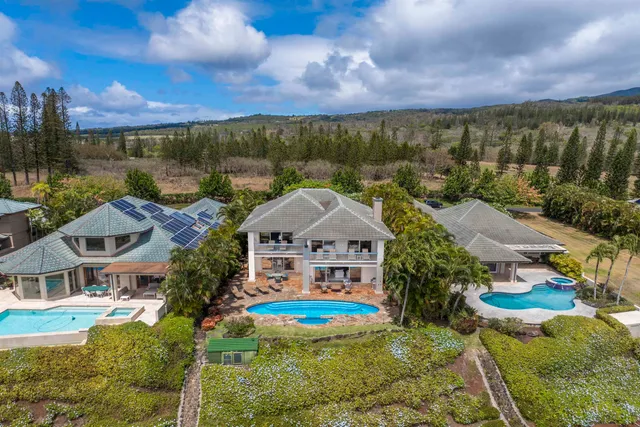 an aerial view of house with yard swimming pool and outdoor seating