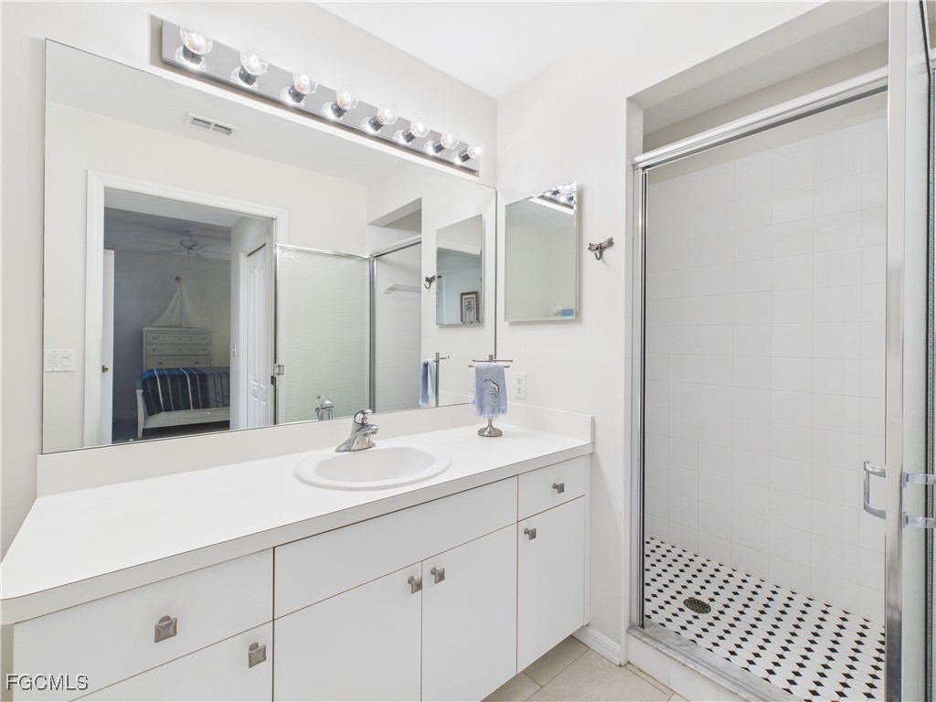 10461 Washingtonia Palm Way, Unit 3436 Fort Myers, FL 33966 - Photo 15 of 32 a bathroom with a sink and a mirror