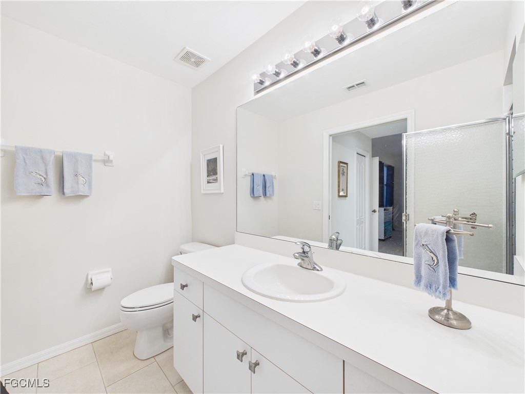 10461 Washingtonia Palm Way, Unit 3436 Fort Myers, FL 33966 - Photo 16 of 32 a bathroom with a sink a toilet and mirror