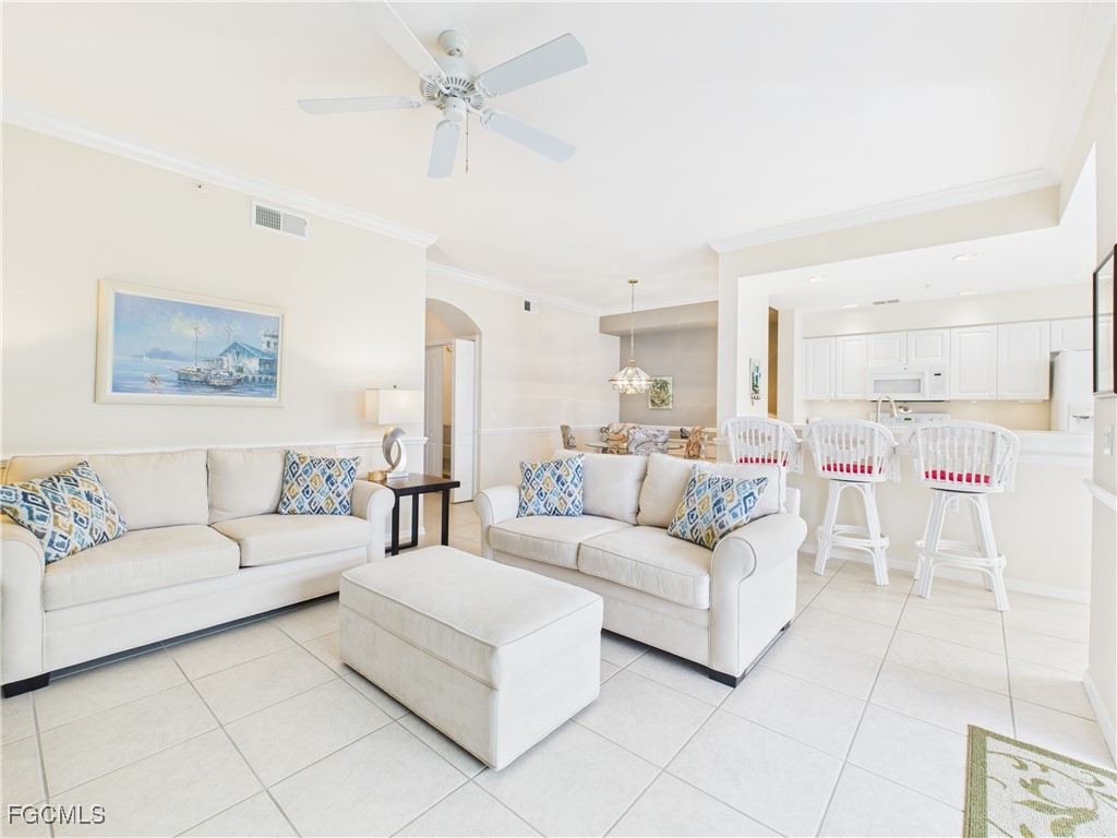 10461 Washingtonia Palm Way, Unit 3436 Fort Myers, FL 33966 - Photo 22 of 32 a living room with furniture and a chandelier