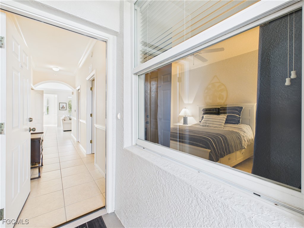 10461 Washingtonia Palm Way, Unit 3436 Fort Myers, FL 33966 - Photo 25 of 32 a bedroom with a bed and a mirror