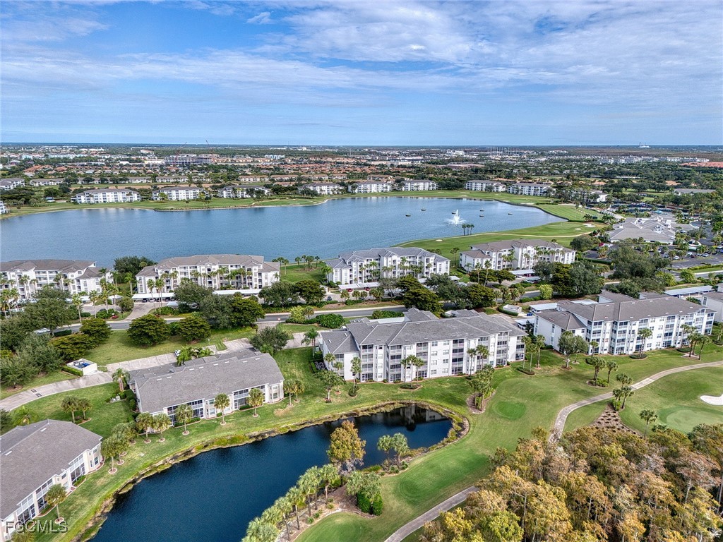 10461 Washingtonia Palm Way, Unit 3436 Fort Myers, FL 33966 - Photo 28 of 32 an aerial view of a city with lots of residential buildings and lake view in back