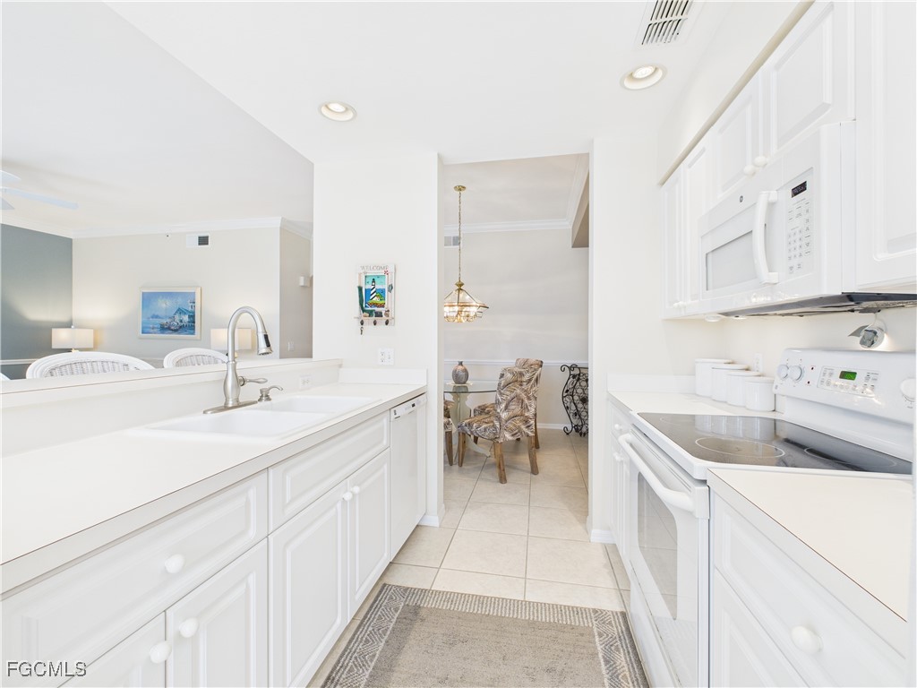 10461 Washingtonia Palm Way, Unit 3436 Fort Myers, FL 33966 - Photo 4 of 32 a en suite bathroom with a sink and a mirror