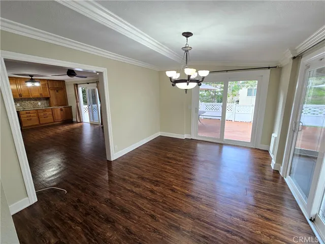 a view of a livingroom with wooden floor staircase and windows