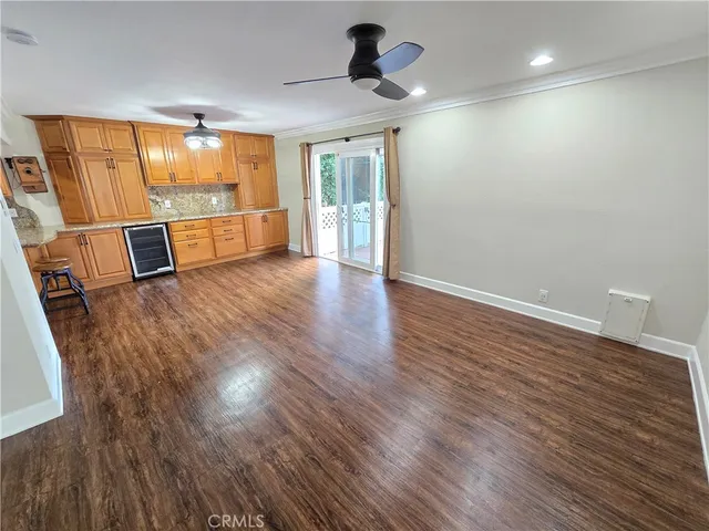 a view of a kitchen with a sink and wooden floor