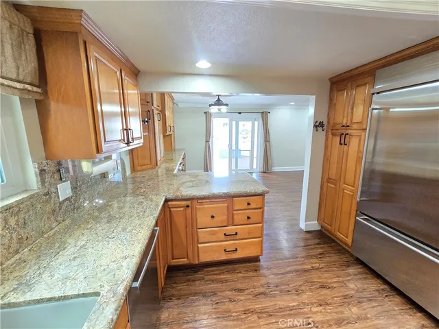 a bathroom with a granite countertop sink a mirror and a shower