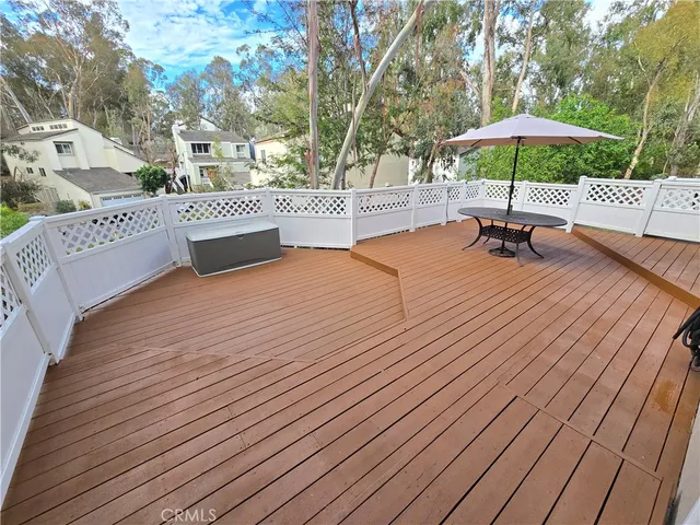 a view of a terrace with chairs and wooden floor