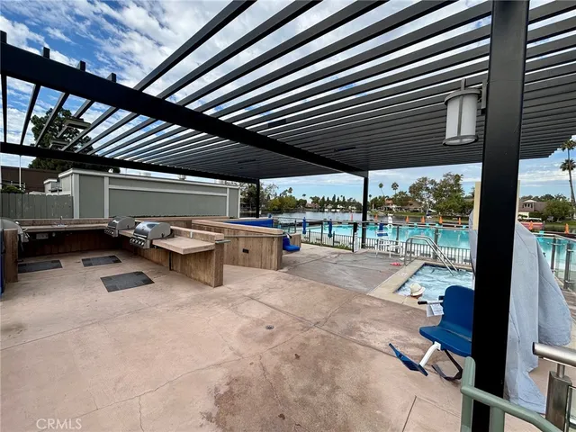 a view of a backyard patio with barbeque grill and floor