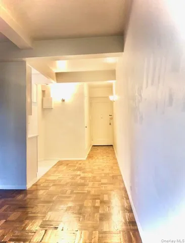 a view of a big room with wooden floor and brick walls
