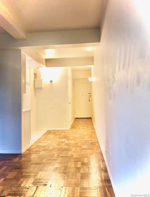 1565 Odell Street, Unit 1F Bronx, NY 10462 - Photo 5 of 10 a view of a big room with wooden floor and brick walls