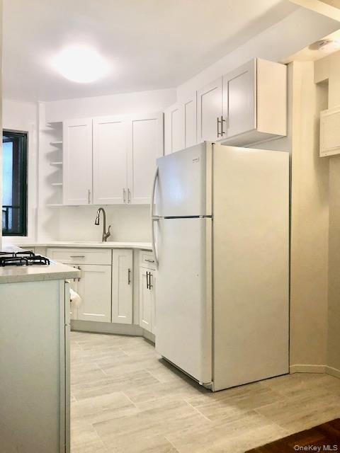 1565 Odell Street, Unit 1F Bronx, NY 10462 - Photo 7 of 10 a white refrigerator freezer sitting in a kitchen