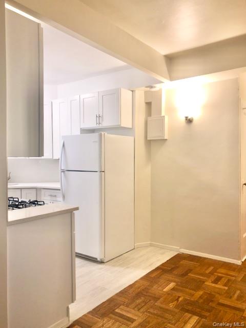 1565 Odell Street, Unit 1F Bronx, NY 10462 - Photo 8 of 10 a view of a kitchen with a refrigerator a stove top oven and a refrigerator