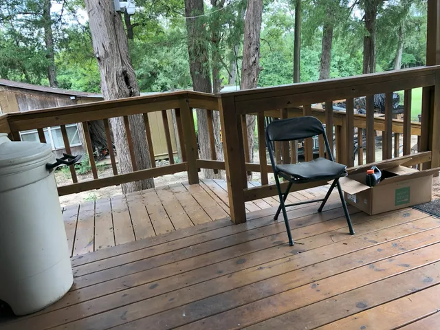 a view of a house with backyard and trees