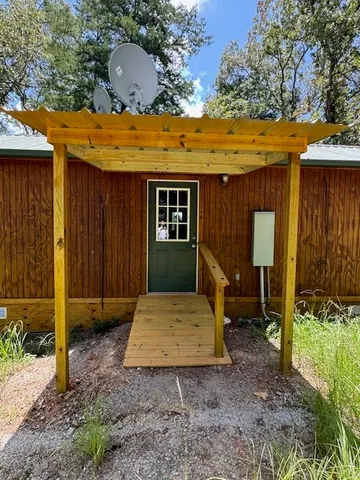 a kitchen with a sink a table and chairs in it