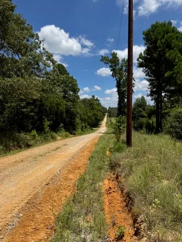 a view of house with backyard space and balcony