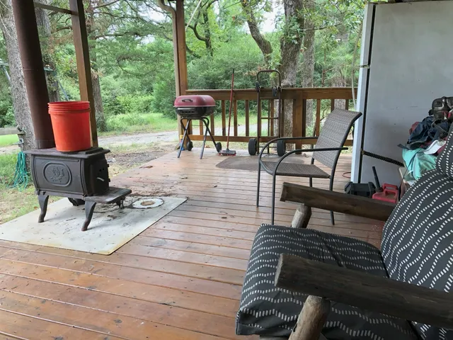 a view of a patio with wooden floor and iron fence