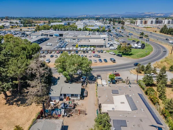 an aerial view of a house with a yard and lake view