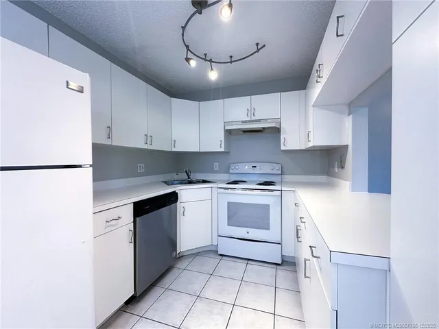 an empty room with wooden floor and a window