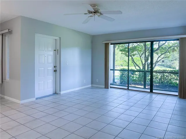 a kitchen with a refrigerator and white cabinets
