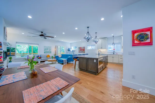 a living room with kitchen island furniture and a wooden floor