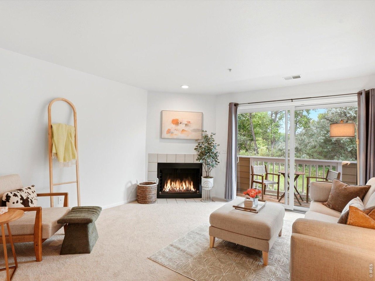 4945 Twin Lakes Road, Unit 46 Boulder, CO 80301 - Photo 7 of 42 Cozy up by the gas fireplace or step onto the west-facing balcony to enjoy mountain views and spectacular Colorado sunsets.