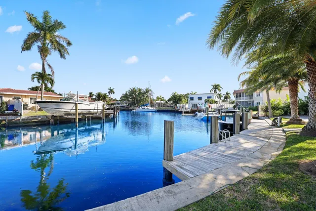 an aerial view of a swimming pool with outdoor seating